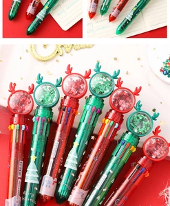 Detail of Christmas multi-color ballpoint pen with sequined reindeer antlers and festive prints