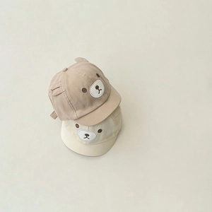 Detail of baby baseball caps featuring 3D bear ears and embroidered bear face design