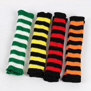 Detailed view of four pairs of striped knitted leg warmers in various vibrant color combinations