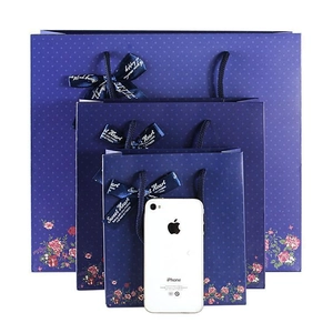 Premium dark blue Christmas gift bags with floral patterns and silk handles in three sizes