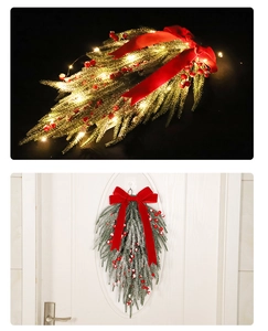 Detail of lit Christmas swag with red velvet bow, berries, and warm LED lights