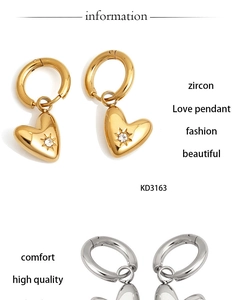 Close-up of gold and silver heart earrings with zircon stones and starburst engraving