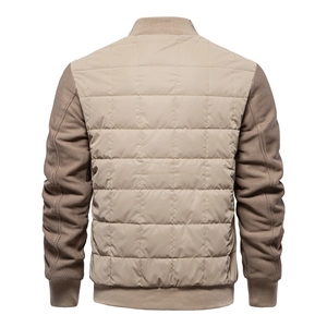 Detail view of khaki quilted jacket back showing diamond patterns and knitted sleeves