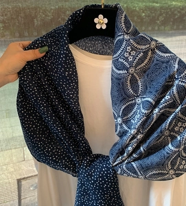 Detail of navy blue cotton linen scarf with white polka dots and vintage floral patterns