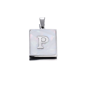 Detailed macro view of silver square letter P pendant with white mother of pearl inlay
