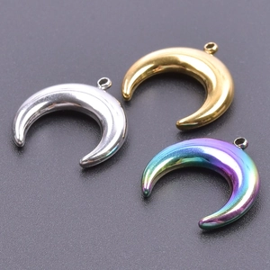 Detailed view of crescent moon pendants in gold, silver, and rainbow titanium steel