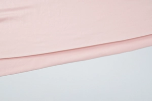 Close-up of pink slim fit slit dress showing fabric texture and neat hemline detail