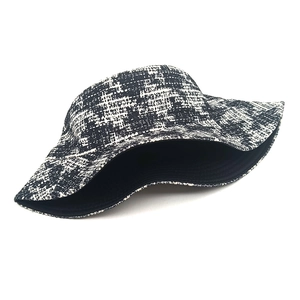 Detailed view of black and white houndstooth pattern texture on a stylish bucket hat