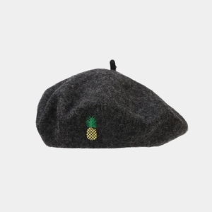 Close-up of fine pineapple embroidery on a dark grey wool blend beret hat for women