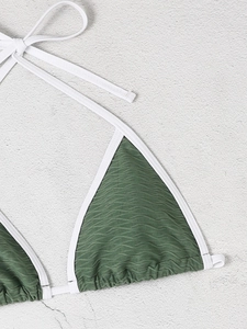 Macro detail of wave textured green triangle bikini top with white neck ties