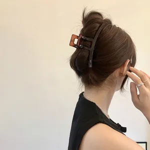 Large amber textured shark hair claw clip for elegant updo hairstyles on a model