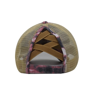 Detail view of tie-dye ponytail baseball cap with breathable mesh and elastic cross bands