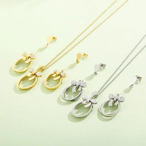 Detailed view of bow tie hollow oval necklace and earrings set with crystal inlay