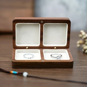 Macro shot of double-slot black walnut wood jewelry box with soft white velvet lining