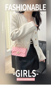 Pink quilted jelly bag featuring a faux pearl handle and gold chain strap on a model