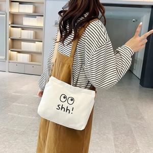 Minimalist white canvas crossbody bag with cute shh expression print for casual daily use