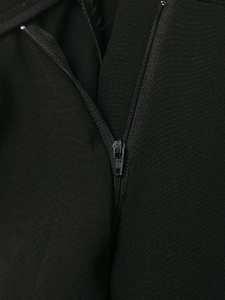 Close-up of the high-quality black zipper detail and textured fabric on casual trousers