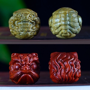 Hand-carved wooden sandalwood beads featuring lion and mythical beast designs in vibrant colors