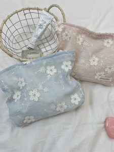 Floral embroidered makeup bags in blue and pink colors with secure zipper closure