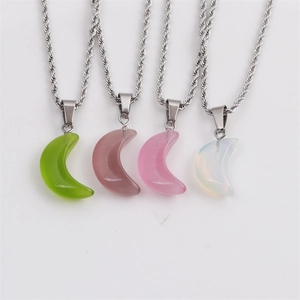 Detail view of four crescent moon stone pendants in green, brown, pink, and white on chains