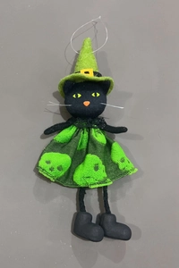 Detailed view of Halloween black cat witch hanging ornament with green hat and skull skirt