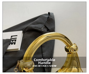 Detailed macro view of the polished golden crescent handle with reflective finish