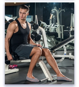 Men wearing light grey five-toe no-show socks in a gym setting with dumbbells
