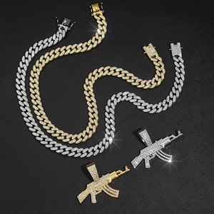 Détail de pendentifs AK47 sertis de strass sur chaînes cubaines en or et argent