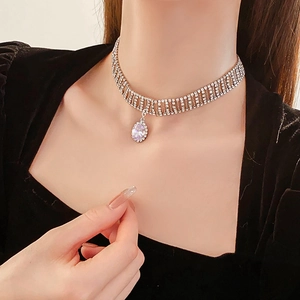 Detail of silver choker necklace with multi-row rhinestones and oval drop pendant