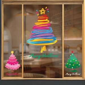 Colorful hand-painted Christmas tree static window decals on a store glass window
