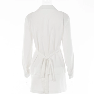 Detail view of the back tie-up design on a crisp white long sleeve mini dress
