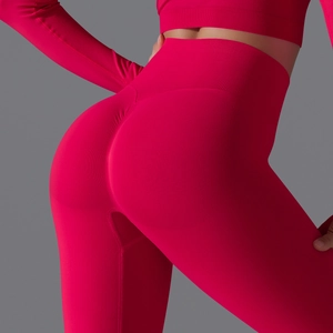 Close-up of seamless magenta yoga set with peach scrunch butt and knit texture
