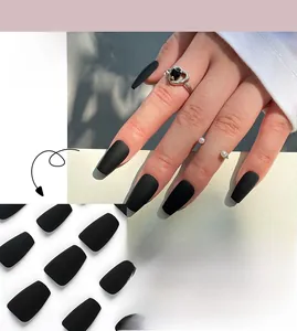 Detailed view of matte black long coffin press-on nails in professional flat lay display