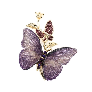 Elegant butterfly brooch with purple embroidery and pearls on a golden branch base