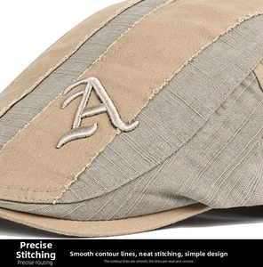 Macro view of linen patchwork cap featuring letter A embroidery and frayed edge details