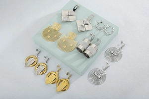Macro shot of stylish gold and silver earring set with minimalist geometric designs