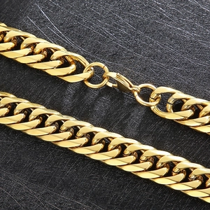 Macro detail of gold stainless steel cuban link chain with high-polish lobster clasp