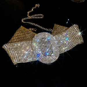 Macro shot of glamorous crystal choker necklace with oval center and gold lobster clasp