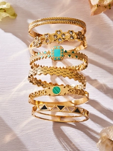 Detailed stack of gold stainless steel bangles with enamel and turquoise inlay designs