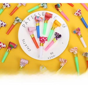 Close-up of colorful party blowouts with polka dots on a bright yellow background