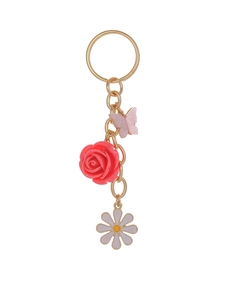 Detail of gold keychain featuring pink butterfly, red rose, and white daisy charms