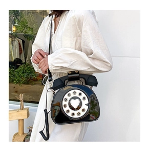 Creative retro black telephone shaped shoulder bag with rotary dial detail shown on model