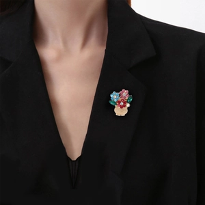 Elegant gold flower basket brooch with colorful crystals pinned on a black suit lapel