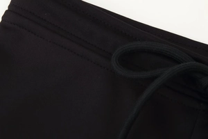 Macro detail of elastic waistband with drawstring on black flared pants set