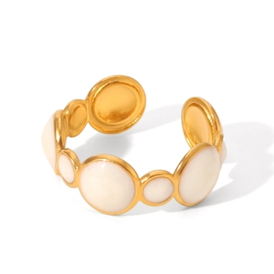 Macro shot of gold-plated open ring featuring inlaid white pearlescent circular accents