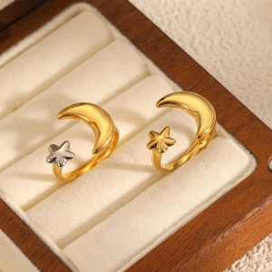 Minimalist stainless steel moon and star open rings in gold and silver finish on velvet