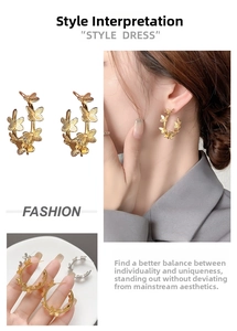 Detail view of gold-plated hollow butterfly hoop earrings with intricate 3D texture design