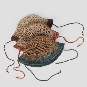 Handcrafted crochet straw sun hat with mesh cutouts and adjustable beaded tassel strap