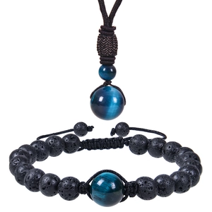 Detail of natural black lava stone and blue tiger eye bead necklace and bracelet set