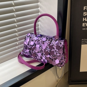 Close-up of purple sequin crossbody bag with metallic sheen and silver chain strap